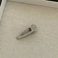 Macro detail of silver drop-shaped hair clip with shimmering inlaid rhinestones - Small Oval Triangle Style / Silver