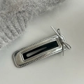 Close-up of a silver rectangular metal hair clip featuring a small bow and textured edges - Hollow Rectangle Silver Bow