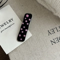 Close-up of Y2K black metal hair clip with pink polka dots on soft knitted fabric - Black Pink Dot Solid Square