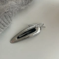 Detail of silver faux leather BB hair clip with bowknot and neat stitching edges - Hollow Water Drop Silver Bow