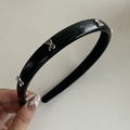 Detail of black faux leather headband featuring small silver metallic bow accents - 2# Black (Silver Bow)