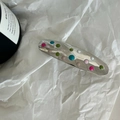 Elegante fermaglio argento con pois colorati su sfondo di carta bianca testurizzata - Stile Ovale Argento con Punti Colorati