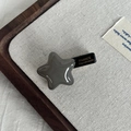 Close-up of star acetate hair clip with FRANCE Handmade engraving and metal side view - Gray