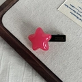 Detail of pink star hair clip showing France Handmade gold lettering on the black side clip - Rose Red