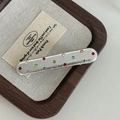 Detail of silver faux leather hair clip with colorful rhinestones on a wooden tray - Silver Long Oval Colorful Rhinestone