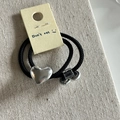Close-up of black elastic hair ties with silver heart and cylinder metal charms on display card - Silver Heart Hair Rope Pair