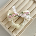 Détail de la broderie florale et de la bordure en dentelle sur le nœud en satin beige - Chouchou Ruban Nœud Blanc Cassé