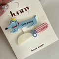 Detail of blue cartoon dachshund and knife-shaped hair clips on packaging card - Blue Dog Pink Knife Pair