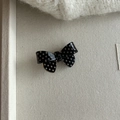 Detail of a black and white polka dot bow hair clip made of glossy acrylic on a soft tray - Black with White Polka Dot Bow Hair Clip