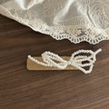 Macro shot of woven rattan hair clip with delicate pearl bow on vintage lace background - Milk Tea Square Double Bowknot