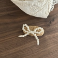 Detail of beaded pearl bow hairpin on woven backing with metal duckbill clip - Milk Tea Oval Pearl Bowknot