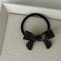 Detailed view of polka dot bow hair tie on a textured tray, retro aesthetic - Coffee Bowknot Hair Tie