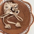 Beige scrunchie with dark ink texture and long ribbon tail in a woven basket - Coffee Texture Ribbon Style