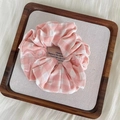 Pink and white checkered scrunchie with embroidered scalloped edges on a display tray - Pink White Gingham Embroidery Style