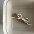 Handwoven straw hair clip with elegant white pearl bow and central pearl accent - Milk Tea Square Pearl Bowknot