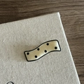 Macro shot of wavy acetate hair clip with classic cream background and black polka dots - Solid Cream Black Polka Dot Style