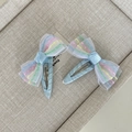 Detail of blue glitter hair clips with rainbow mesh bows on a display tray - Color Mesh Water Drop Bow Style