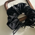 Close-up of black pleated fabric scrunchie with a silver heart-shaped metal pendant - 6# Black Scrunchie With Single Heart Bow