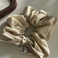Elegant beige satin scrunchie featuring a polished silver heart charm and textured fabric - 5# Milk Tea Scrunchie With Single Heart Bow