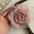 Detail of a handmade pink mesh silk rose clip held in hand to show size and texture - Pink Flower Hair Tie