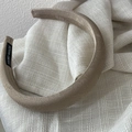 Detail of champagne gold satin headband showing woven jacquard texture and hand made label - Wide Version / Coffee