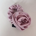 Elegant pink fabric rose scrunchie with shimmering texture for a retro floral hair style - Pink