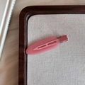 Close-up of pink seamless candy-colored hair clip on a wooden tray with linen - Deep Pink
