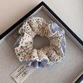 Elegant double-layered lace and blue chiffon scrunchie on a gray display tray - Blue