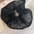 Detailed view of large black lace scrunchie with intricate floral patterns and textures - Large Mesh Scrunchie / Black