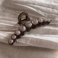 Elegant dark brown translucent acrylic hair claw clip with cream pearls on beige fabric - Coffee Beaded Clip