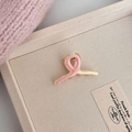 Detail van een roze en beige tweekleurige mini haarklem met spiraalvormig kruisontwerp - Roze Geel Patchwork Haarklauw