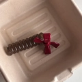 Brown spiral hair tie with red glossy ribbon bow on minimalist beige fiber tray - Wine Red Bowknot