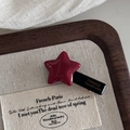 Close-up of red star hair clip with France Handmade lettering on a beige linen tray - Wine Red Star Hair Clip
