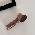 Close-up of heart-shaped amber pattern hair clip with brown spiral design details - Milk Tea Brown