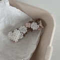 Vintage lace embroidered flower hair clip with white pearl heart detail on beige background - Brown Lace White Heart
