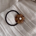 Detail shot of brown amber flower hair tie with pearl center on beige fabric - Tortoiseshell (6#)