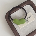 Minimalist elastic hair tie with avocado green heart charm on a linen card - Heart Hair Tie / Green