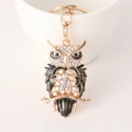 Golden owl keychain pendant featuring white crystals and black enamel detailing - Black
