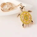Golden sea turtle keychain with yellow rhinestones and enamel for bag and car decor - Yellow