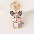Portachiavi a forma di cane in metallo dorato con strass viola e blu e smalto bianco - Viola