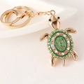 Golden turtle keychain with green crystals and enamel shell detail for bags - Green