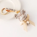 Luxury teddy bear keychain with crystals, golden crown, and personalized letter H charm - White And Champagne
