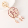 Llavero atrapasueños dorado con diamantes rosa y colgantes de mariposa y plumas - Rosa