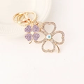 Exquisite gold clover keychain with purple rhinestones and luxury lobster clasp on white background - Purple