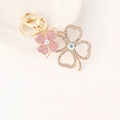 Golden keychain with pink and white rhinestone four-leaf clover charms on white background - Pink