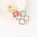 Golden clover keychain with pink and blue rhinestones and iridescent gems - Blue