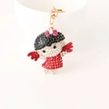 Cute cartoon girl keychain with black and red crystals on a gold lobster clasp - Red