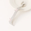 Funkelnder Schlüsselanhänger Kamm mit Strass, rosa Schmetterlingen und silbernem Karabiner - Silber