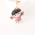 Cartoon girl keychain with pink rhinestones and golden base for bags or keys - Pink