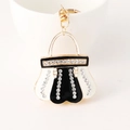 Portachiavi a forma di borsa dorata con smalto bianco e nero e strass lucidi - Nero e Bianco